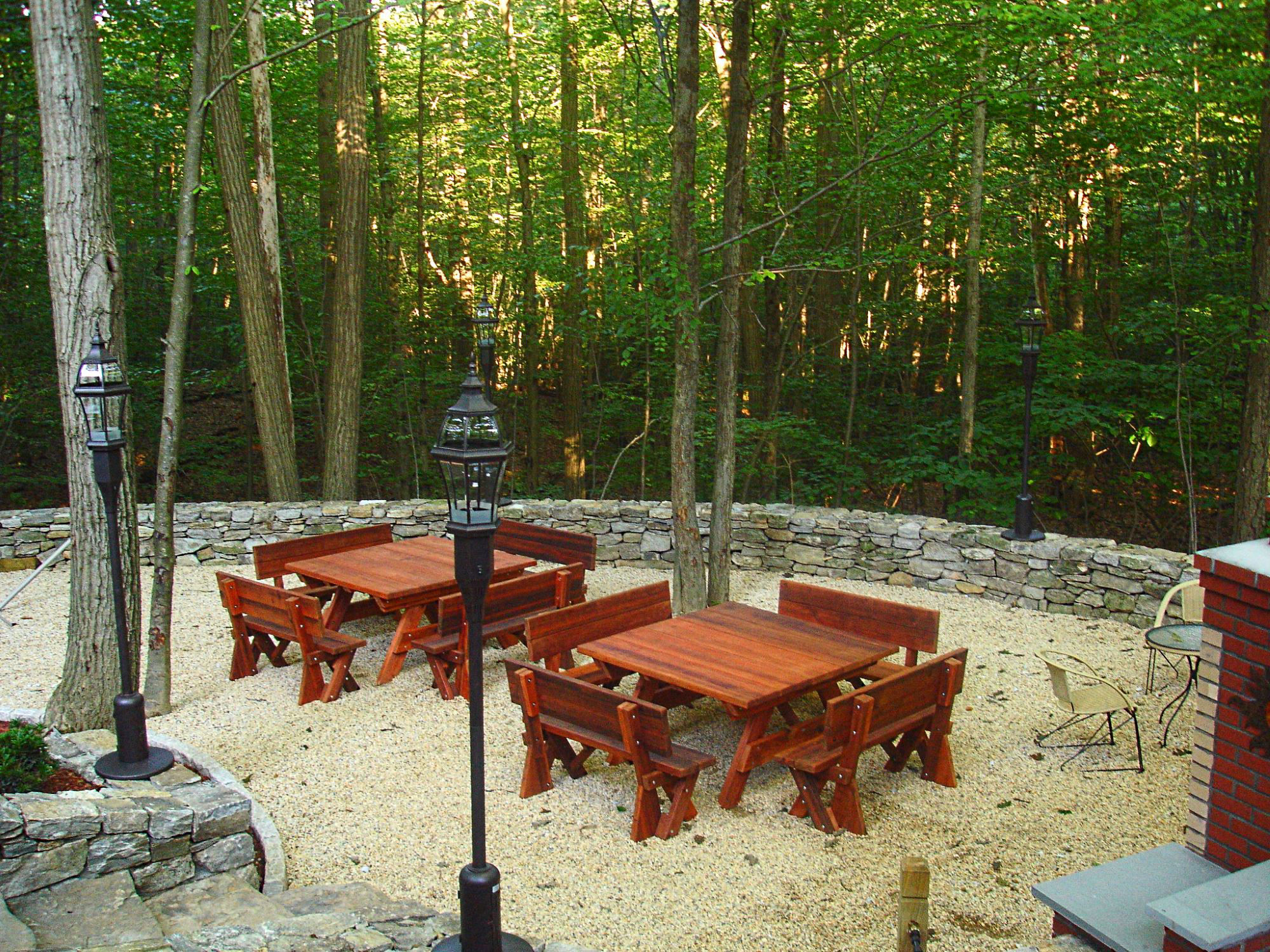 Private picnic area with redwood tables and stone BBQ